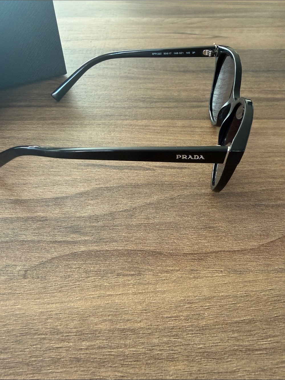 Prada Woman’s Black Frame Sunglasses with Dark Lenses - Picture 2 of 4
